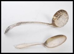A silver hallmarked tea strainer of curved form ha