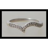 A hallmarked 9ct white gold wishbone ring having f