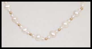 A 20th Century pearl necklace having repeating gra