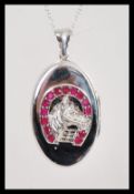 A stamped 925 pendant locket having a raised horse