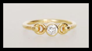 A hallmarked 18ct gold ring set bezel set with a b