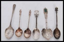 A collection of six teaspoons spoons to include th
