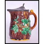 A 19th Century Victorian Majolica oak jug having a