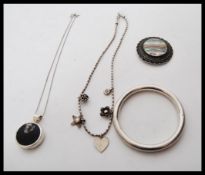 A selection of silver jewellery to include a stamp