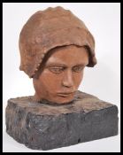 A 19th Century carved wooden bust head of a child