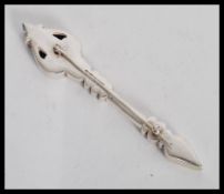 A silver hallmarked brooch in the form of an arrow