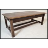 A 19th Century Victorian farmhouse dining table with a single fitted drawer raised on shaped