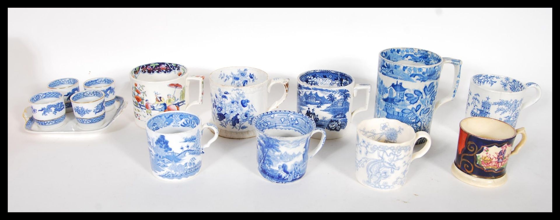 A collection of 19th Century Victorian Staffordshire mugs and cups, most having blue and white