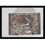 An early 20th Century silver hallmarked matchbox holder having repousse decoration of a stag with