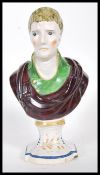 A 19th Century Staffordshire bust of a young gentleman wearing a green coat with a neckerchief and