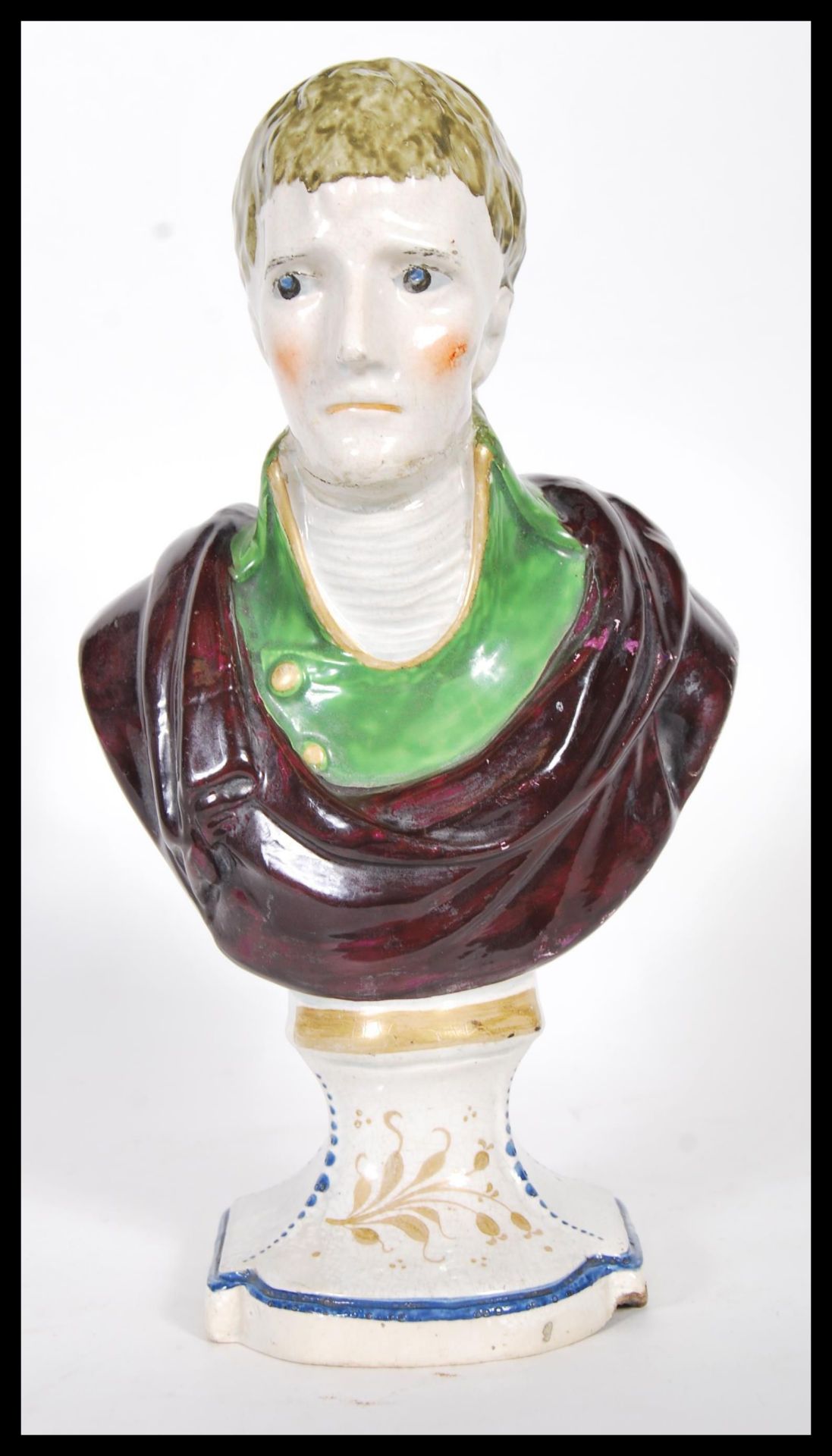 A 19th Century Staffordshire bust of a young gentleman wearing a green coat with a neckerchief and