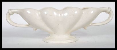 A early 20th century cream glazed pottery plant vase / table centerpiece, designed by florist and