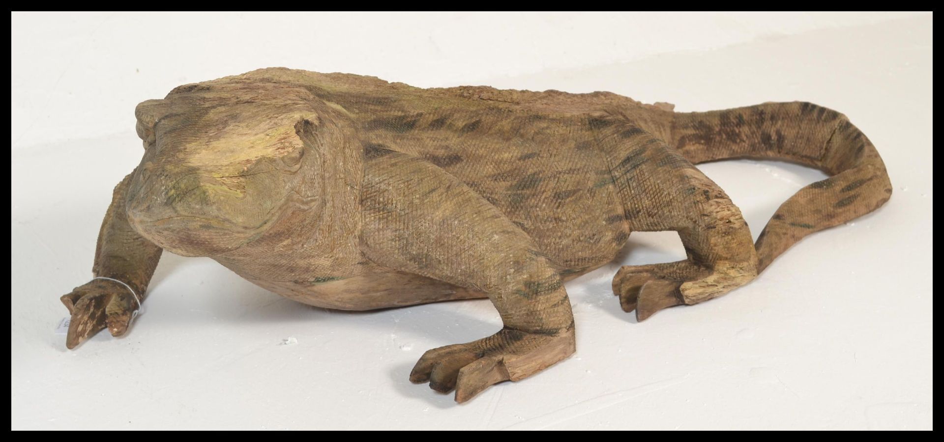 A large 20th Century folk art carved wooden Komodo dragon being well weathered. Measures 28cms