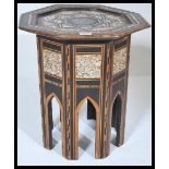 A 19th century Moorish mother of pearl inlaid hardwood octagonal occasional table raised on a shaped