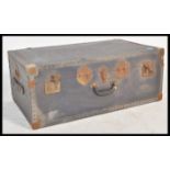 A vintage 20th century steamer trunk, hinged lid s