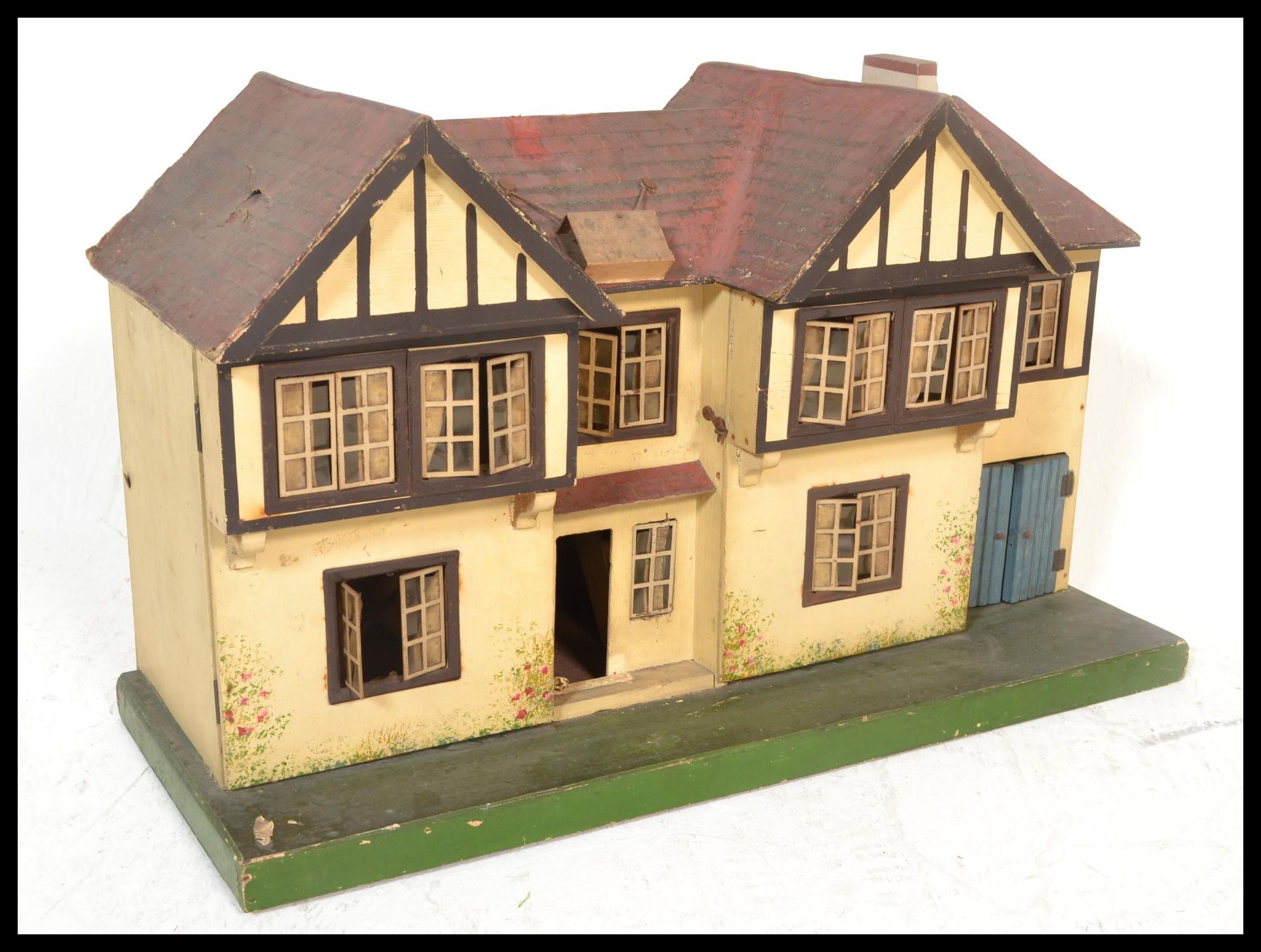 A vintage mid 20th Century dolls house possibly by Triang, the detached house opening from the