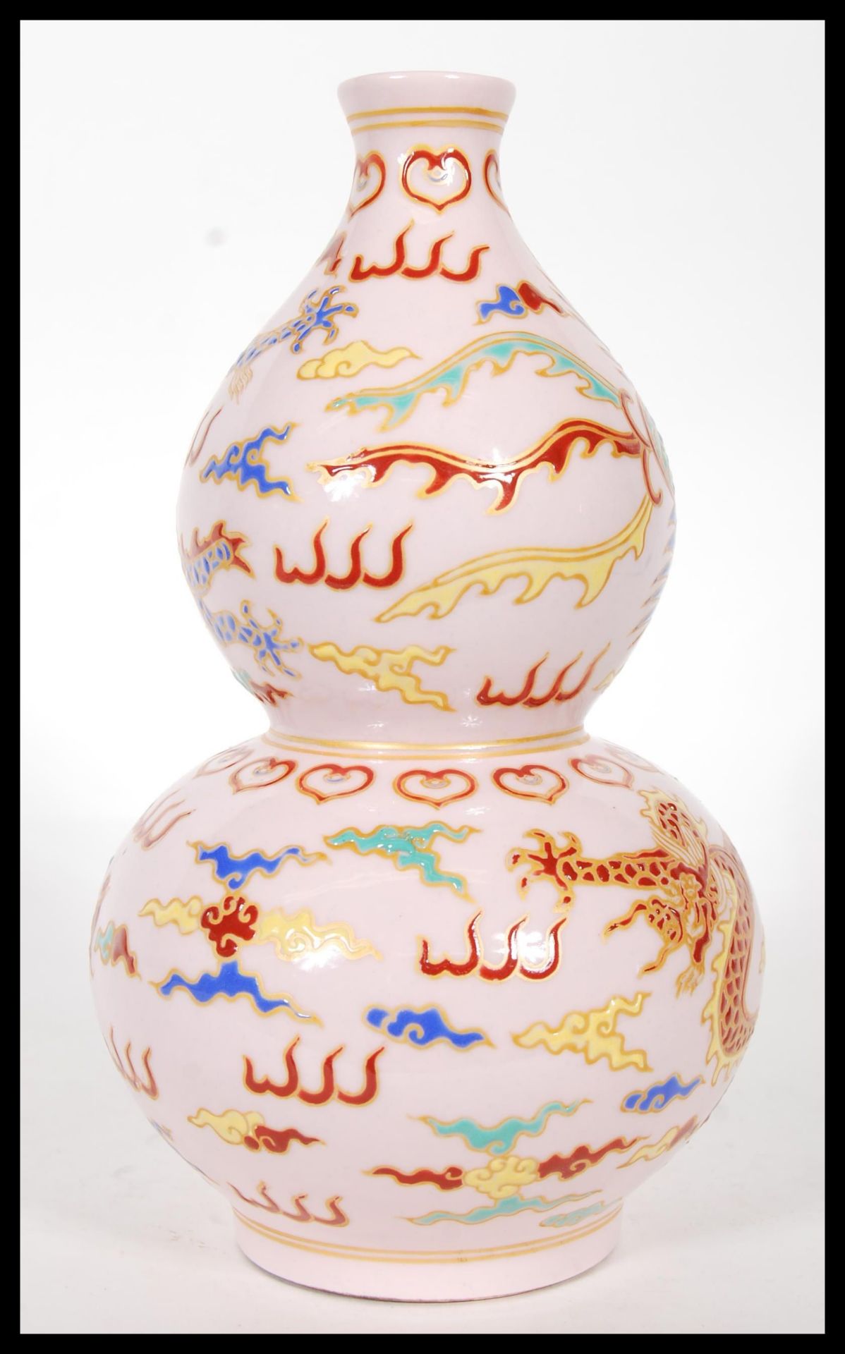 A 20th Century Chinese double gourd vase, having pink ground depicting a dragon and phoenix