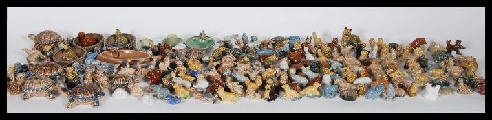 A large collection of vintage ceramic Wade whimsies to include tortoises, dogs, lions, owls,