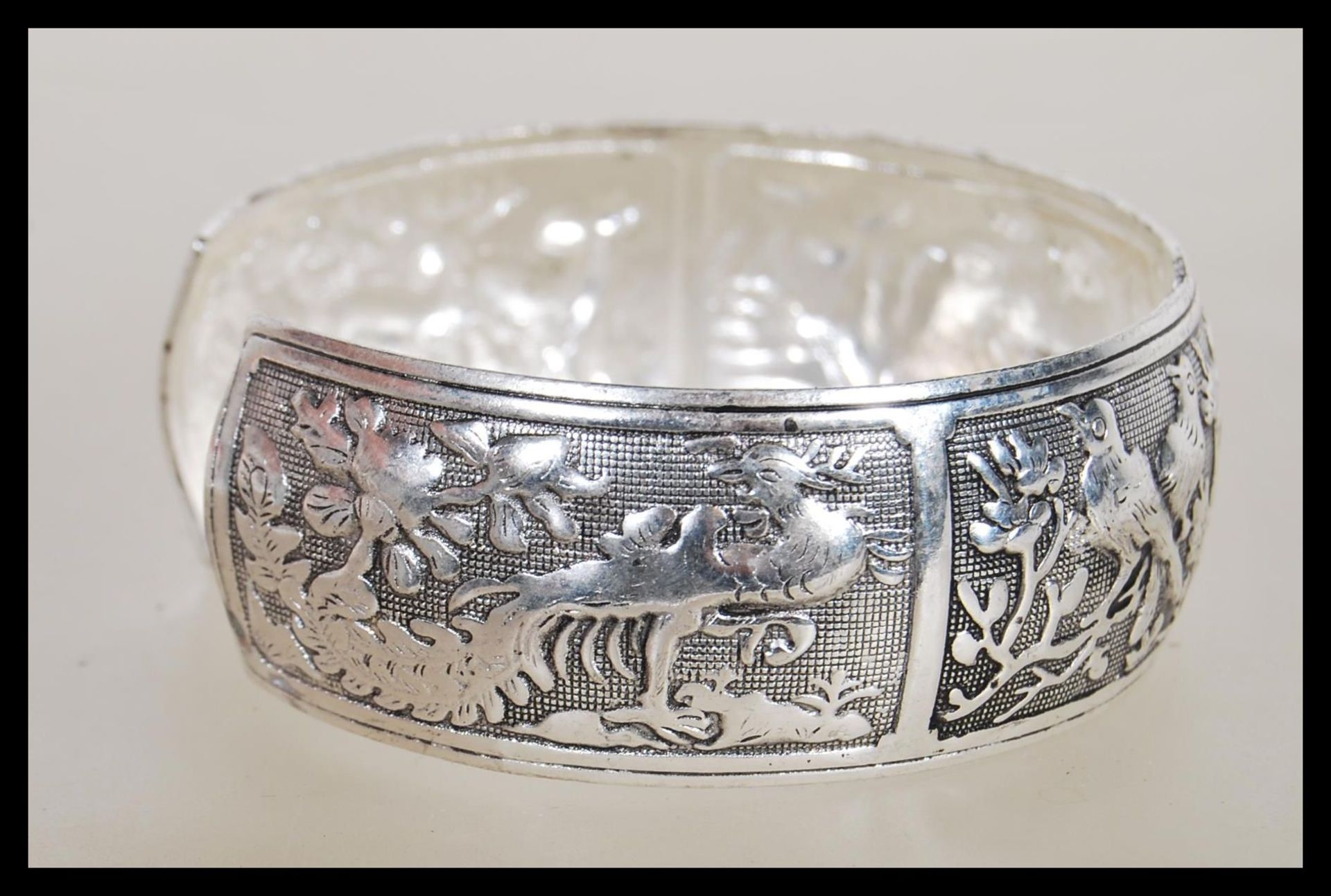 A Chinese silver bangle having panels of repousse decoration of animals including mandarin ducks, - Bild 3 aus 6