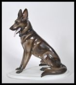 A vintage 20th Century Zsolnay ceramic figurine ( stamped  5566 ) modelled as a seated Alsatian /