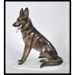 A vintage 20th Century Zsolnay ceramic figurine ( stamped  5566 ) modelled as a seated Alsatian /