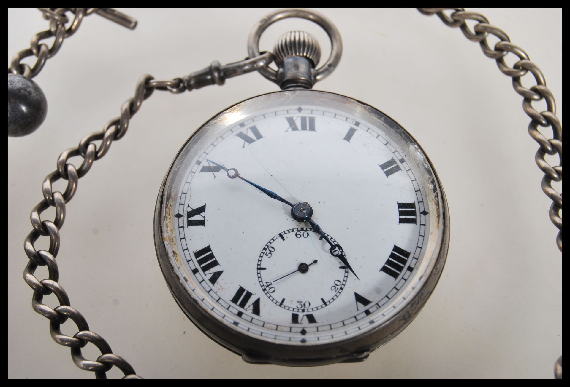 An early 20th Century silver pocket watch having a white enamelled face with roman numerals to the - Image 5 of 9
