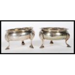 A pair of 19th Century silver hallmarked table salt condiments raised on three cab feet with