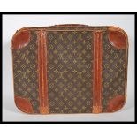 A Louis Vuitton hard suitcase in monogram canvas, second half 20th century, covered in LV monogram