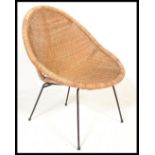 A vintage retro 20th Century wicker satellite sputnik atomic chair raised on ebony tubular legs