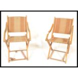 A pair of vintage first half 20th Century folding metamorphic picnic / camping chairs, each chair