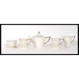 A vintage Art Deco 1920's tea for two service having a cream ground with silver patterning to the