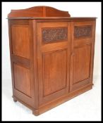 A 19th Century Victorian sideboard / buffet, gallery back over flared top, panel doors with carved