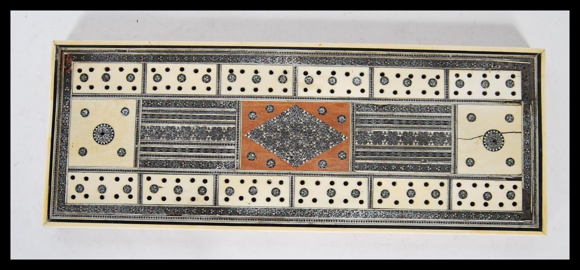 A late 19th Century Anglo Indian Colonial Vizagapatam cribbage board, having ivory, bone and micro