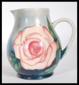 A  Moorcroft Collectors Club tubed lined jug decorated with a Rose pattern on a blue ground, stamped