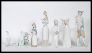 A collection of six Lladro figurines to include: The boy with the goat D 30,  Young girl holding a