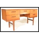 A retro 20th Century teak wood chest of drawers / desk