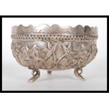 A 20th Century Anglo Indian silver bowl having repousse decoration featuring a landscape with