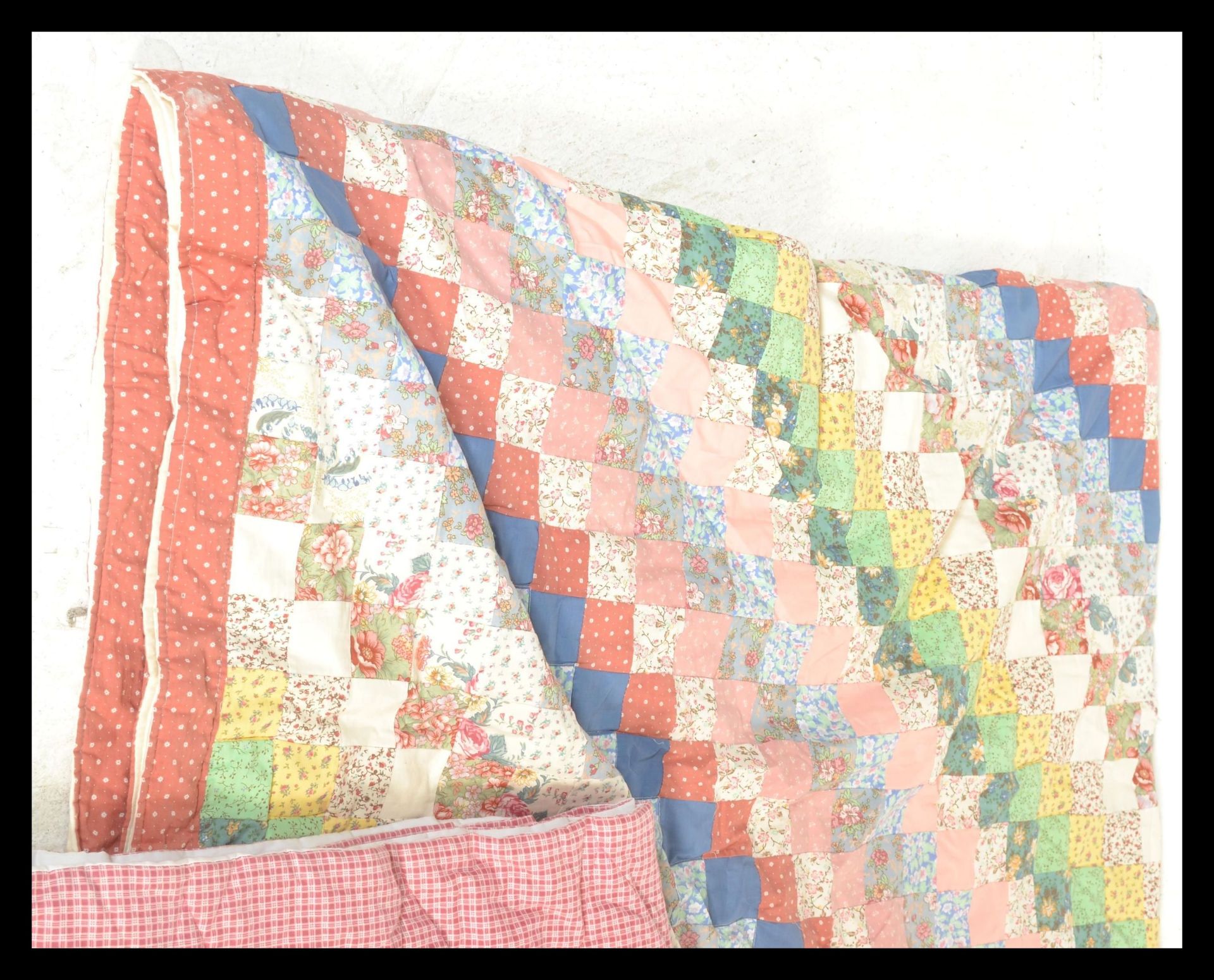 A collection of three vintage 20th Century quilts / bed throws to include an eider down filled quilt - Image 3 of 5
