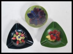 A group of three pieces of tube lined Moorcroft pottery, the first being a pin dish and the other