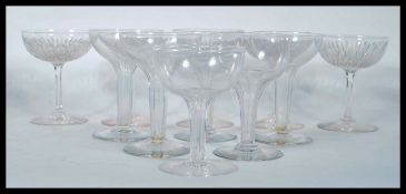 A collection of 19th century / early 20th century champagne glasses, the bowls set on tall stems