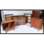 A pair of mid century retro oak sliding glass door bookcases together with a walnut glass bookcase