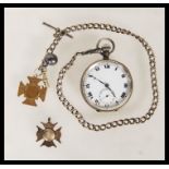 An early 20th Century silver pocket watch having a white enamelled face with roman numerals to the