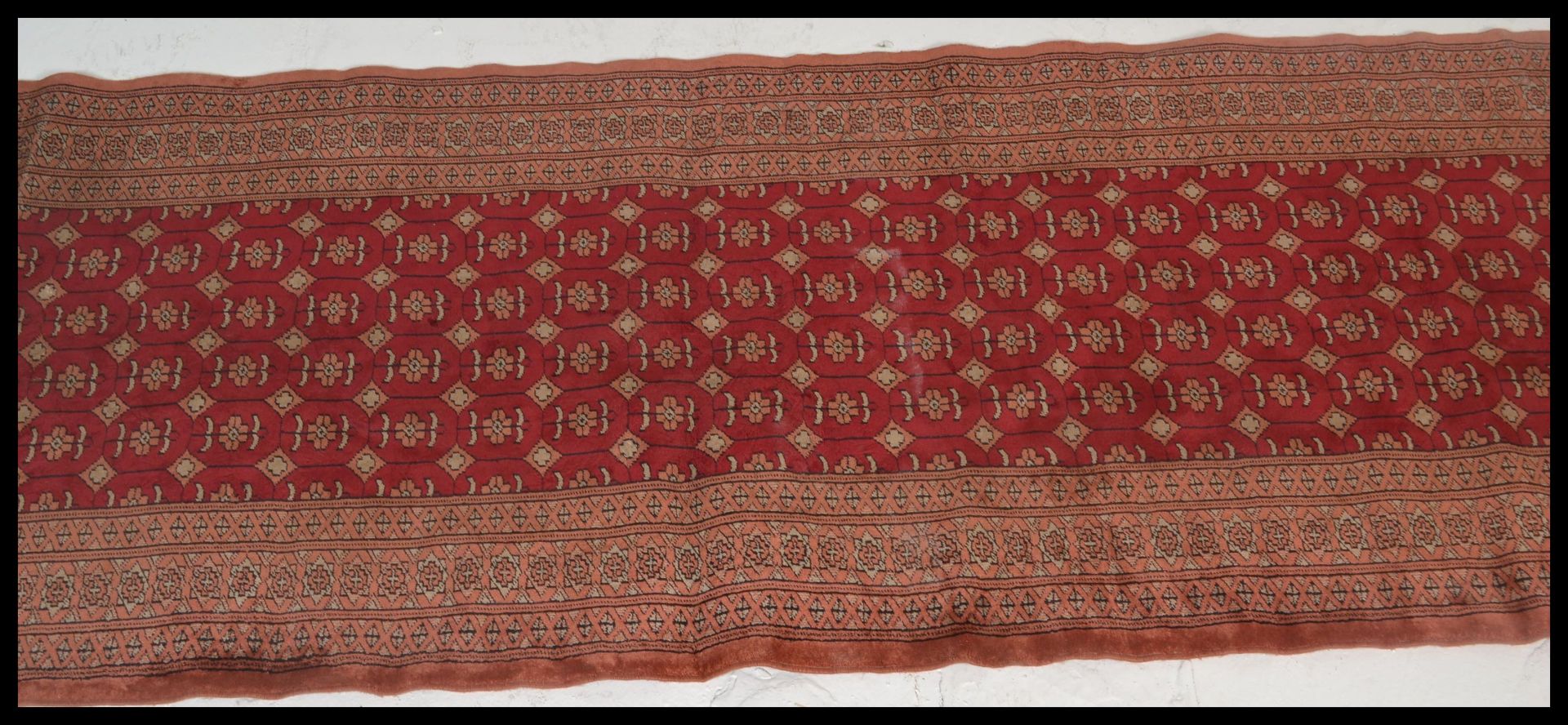 A vintage woolen Persian / Islamic floor rug runner set  on red ground,central panel with - Image 3 of 5