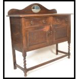 An early 20th Century Edwardian oak mirror back sideboard / credenza, fitted with a pair of panel
