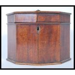 A 19th Century Georgian mahogany tea caddy in octagonal form having a hinged lid opening to reveal a