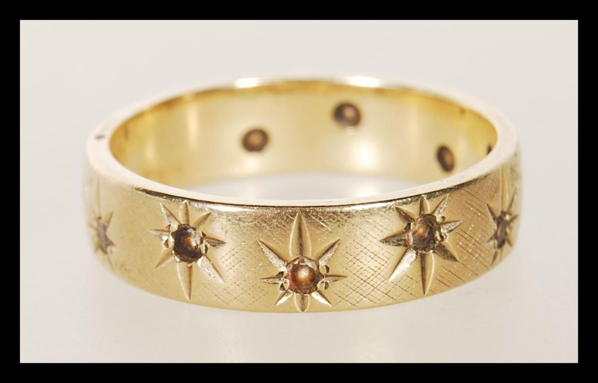 A hallmarked 9ct gold ring being gypsy set with with stones. Hallmarked Birmingham 1970. Weight 5.