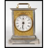 A 20th Century German made carriage clock. The clock of classical form, chrome case with gilt rococo