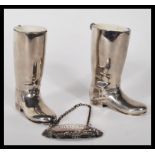 A pair of 20th Century silver plated drinks measures in the form of riding boots having raised