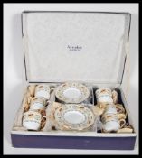 A 20th Century Aynsley coffee set in the Banquet pattern, consisting of six cups and saucers