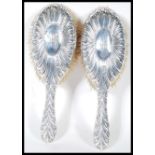 A pair of Victorian 19th century silver hallmarked ladies clothes brushes by Willam Comyns bearing